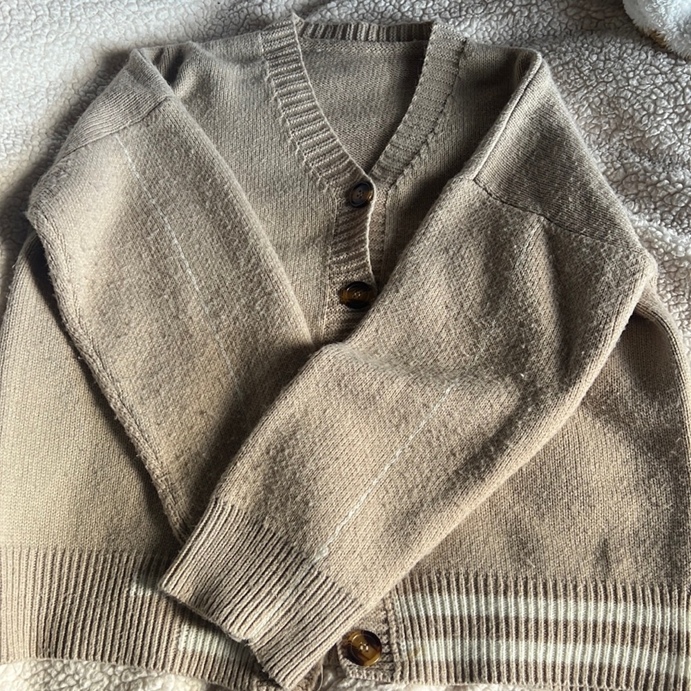 Brown cardigan with white details.